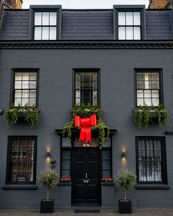Red Plastic Bow On A Building a t Christmas
